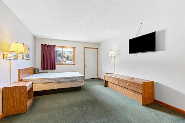 carpeted bedroom featuring a textured ceiling