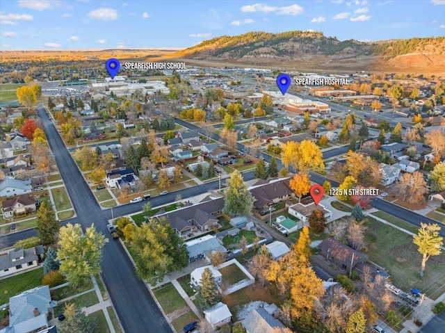 aerial overview of property's location featuring nearby suburban area and a mountain backdrop