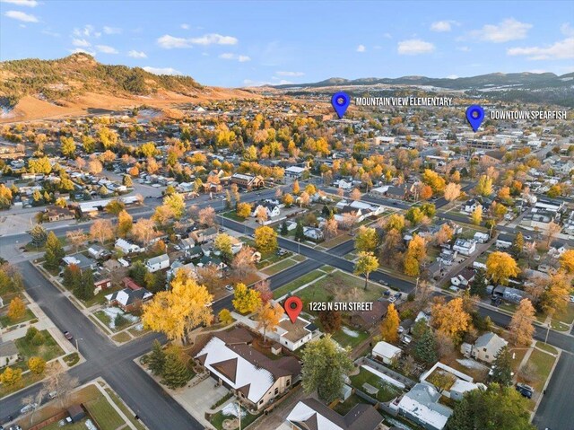 aerial overview of property's location featuring mountains and nearby suburban area