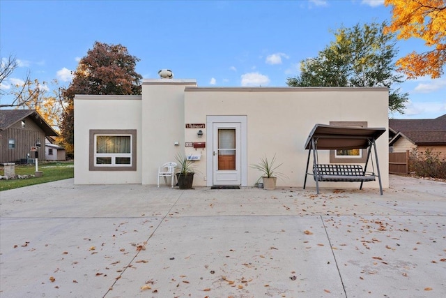 view of front of house featuring a patio and stucco siding