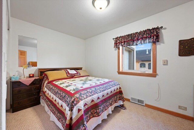 carpeted bedroom featuring baseboards