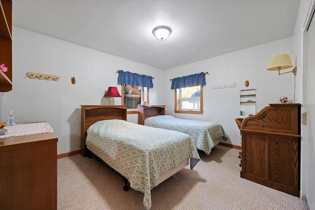 bedroom featuring light carpet and baseboards