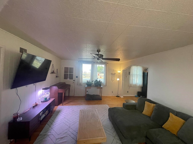 living room with wood-type flooring and ceiling fan