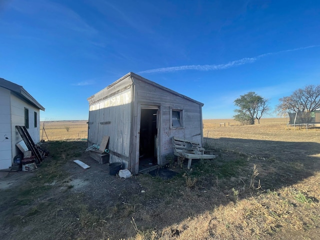 view of outdoor structure with a rural view