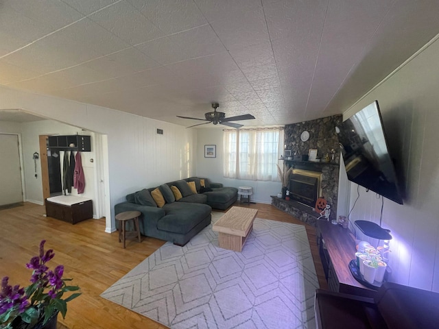 living room with a fireplace, hardwood / wood-style flooring, and ceiling fan