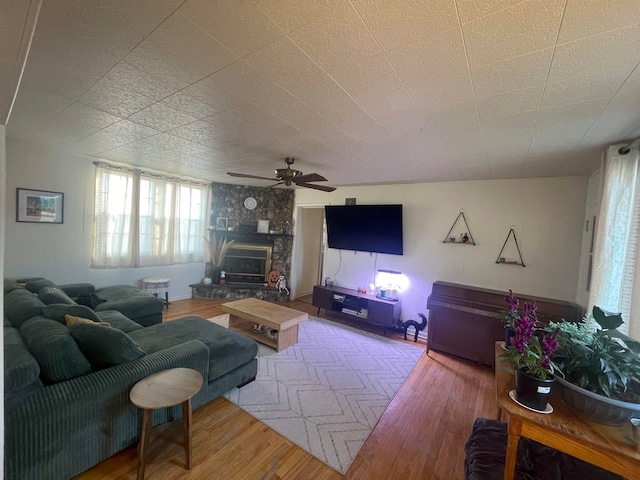 living room with wood-type flooring and ceiling fan