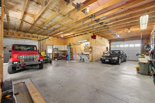 garage featuring a garage door opener and a workshop area