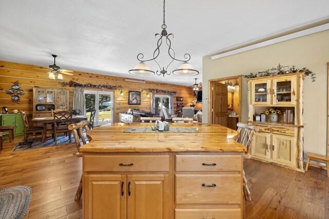 kitchen with butcher block counters, light hardwood / wood-style floors, and a kitchen island