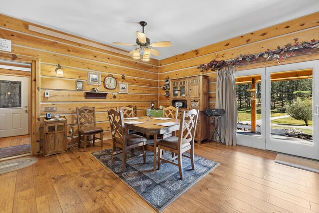 dining area with light hardwood / wood-style flooring and ceiling fan