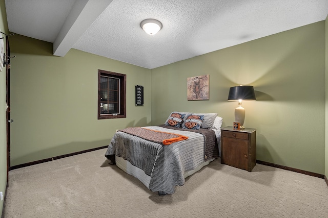 bedroom featuring a textured ceiling, beamed ceiling, and light carpet