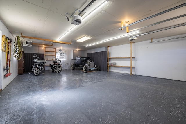 garage with a garage door opener and a wall unit AC