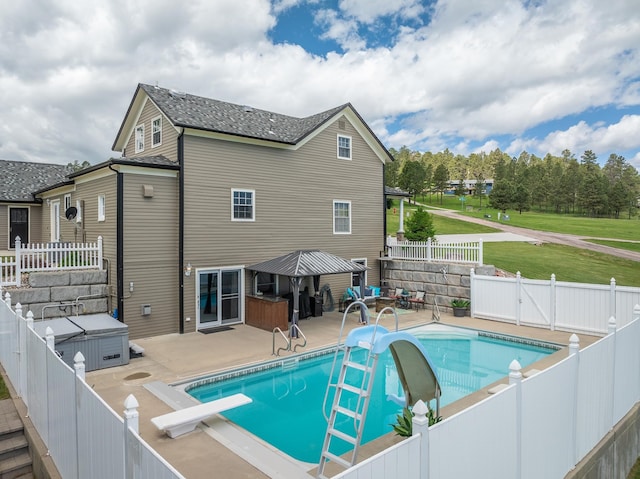 view of pool featuring a patio and a diving board