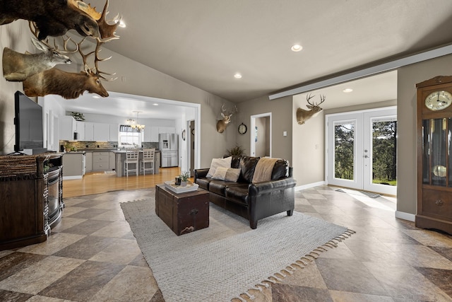 living room with lofted ceiling and french doors