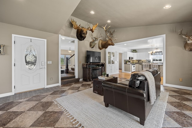 living room featuring an inviting chandelier and vaulted ceiling