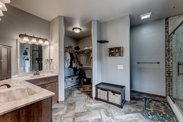 bathroom featuring vanity and a shower with shower door