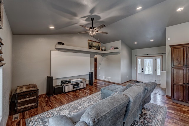 home theater with hardwood / wood-style floors, lofted ceiling, and ceiling fan