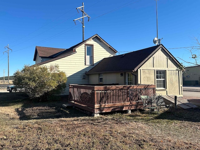 back of property featuring a deck