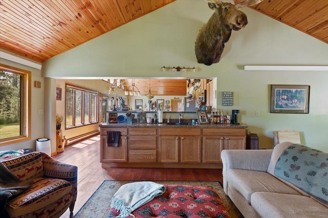 interior space with sink, baseboard heating, high vaulted ceiling, wood ceiling, and light wood-type flooring