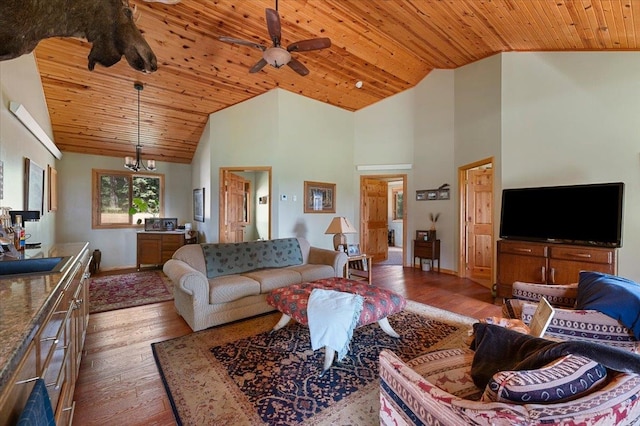 living room featuring light hardwood / wood-style floors, sink, ceiling fan with notable chandelier, high vaulted ceiling, and wood ceiling