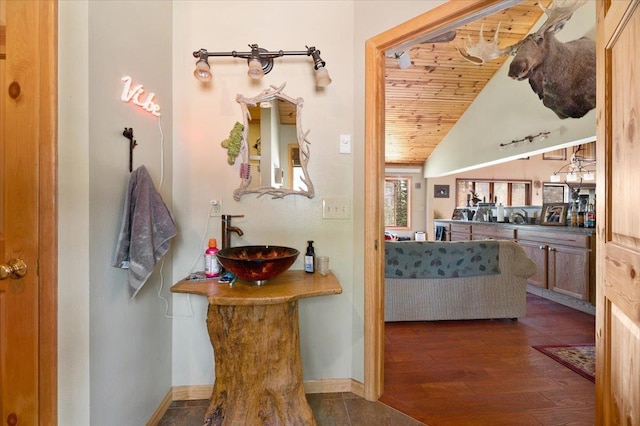 bathroom featuring hardwood / wood-style floors, wood ceiling, sink, and vaulted ceiling