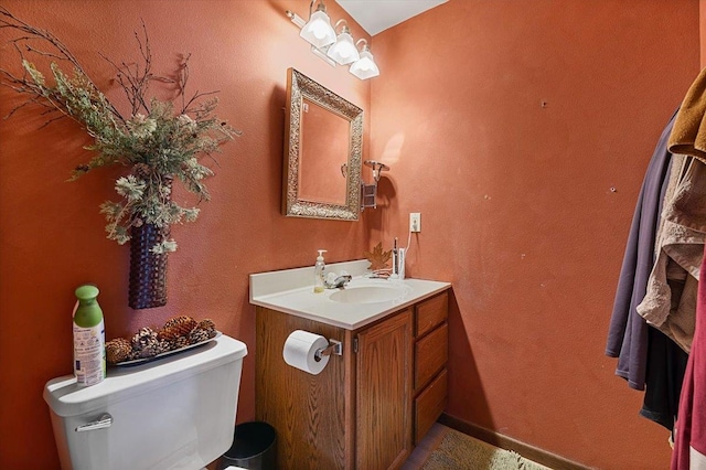 bathroom featuring toilet and vanity