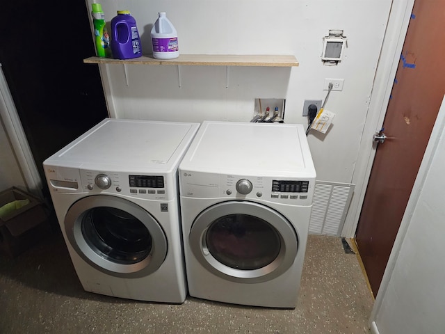 clothes washing area featuring separate washer and dryer