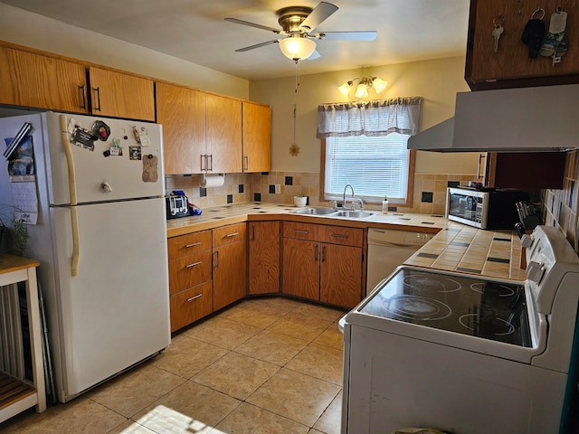 kitchen featuring white appliances, sink, ceiling fan, light tile patterned floors, and tasteful backsplash