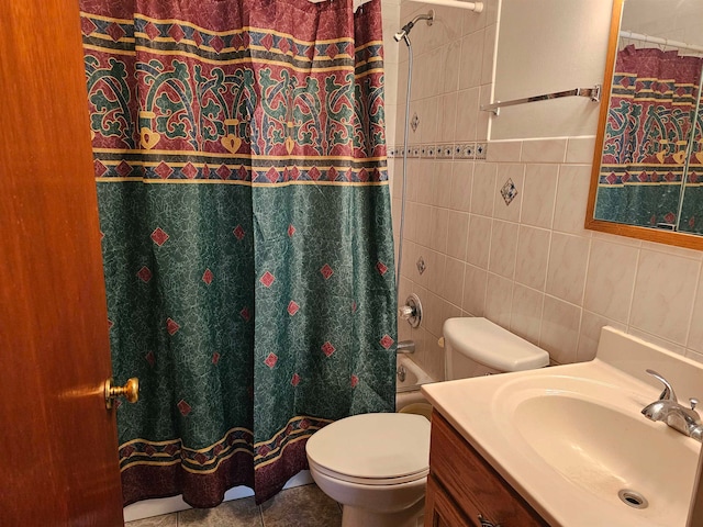 full bathroom featuring tile patterned flooring, vanity, toilet, and tile walls