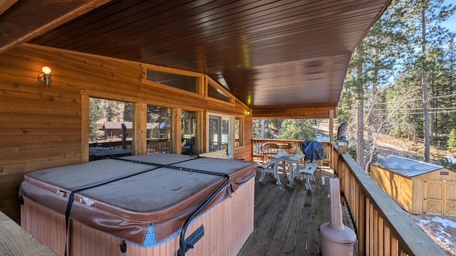 wooden deck featuring a hot tub