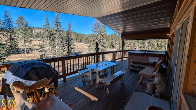 wooden terrace with a hot tub