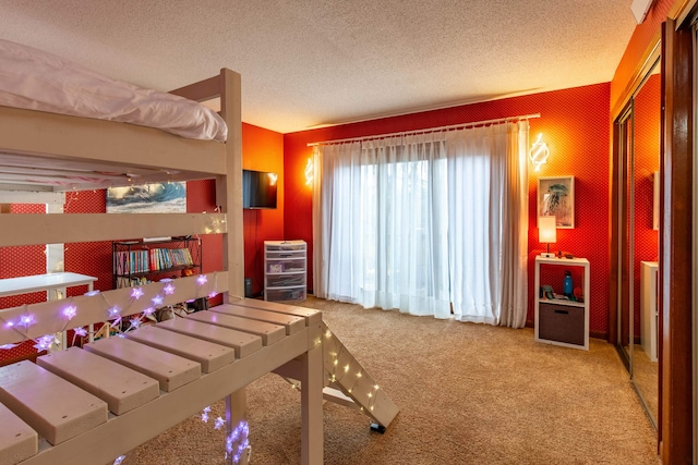 bedroom with a textured ceiling and carpet flooring