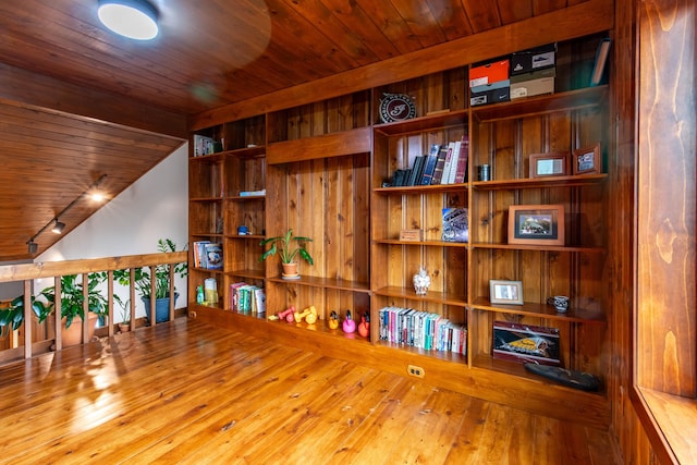 interior space with hardwood / wood-style floors, wood ceiling, and track lighting