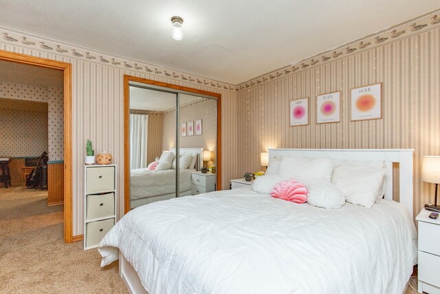 bedroom with a closet and light colored carpet