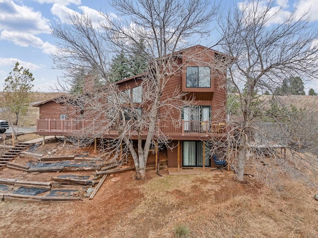 rear view of property featuring a deck