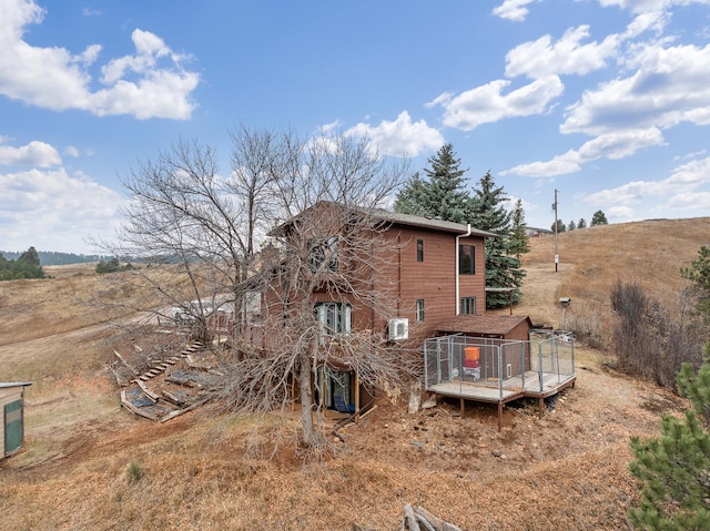 rear view of property with a deck and a rural view