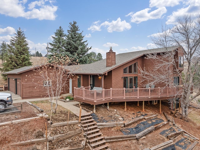 rear view of house featuring a wooden deck