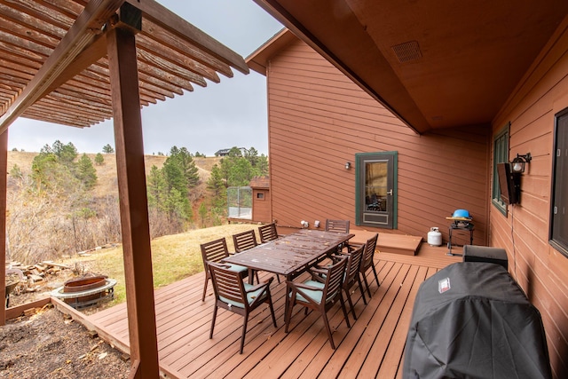 deck with area for grilling, a pergola, and a fire pit