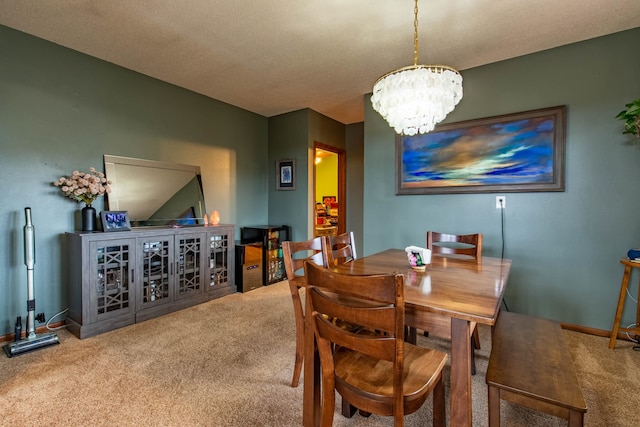 dining room with carpet floors, a textured ceiling, and an inviting chandelier