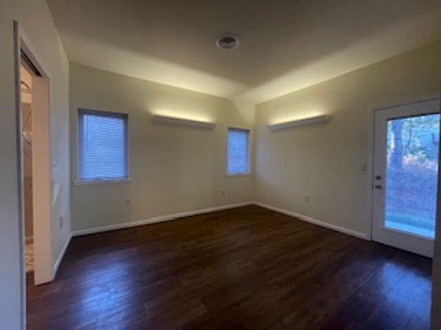 spare room with dark hardwood / wood-style flooring