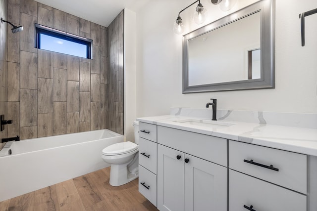 full bathroom with washtub / shower combination, toilet, wood-type flooring, and vanity