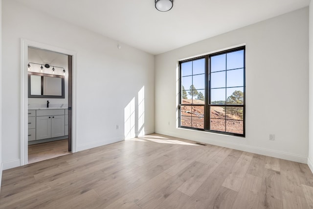 empty room with light hardwood / wood-style floors