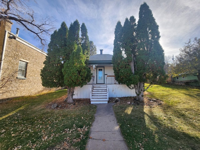 obstructed view of property featuring a front lawn