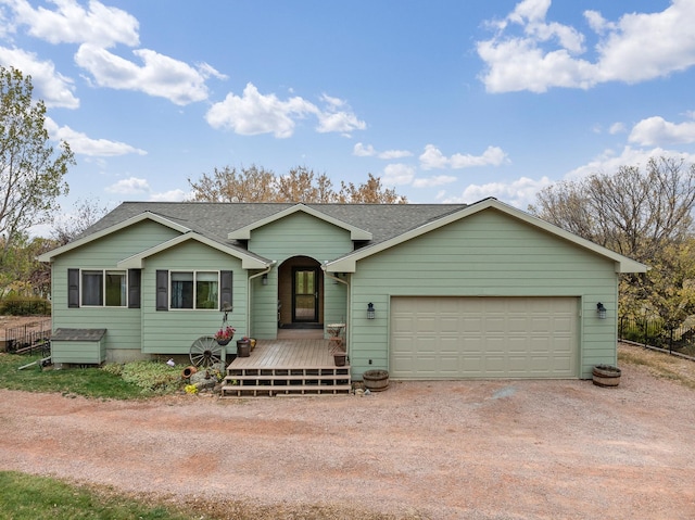 single story home featuring a garage and a deck