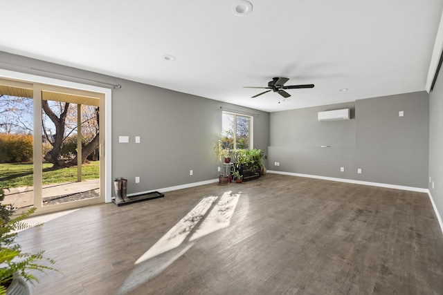 unfurnished room featuring a wall unit AC, ceiling fan, and dark hardwood / wood-style flooring