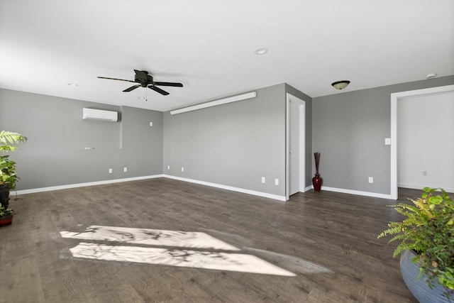 empty room with dark hardwood / wood-style flooring, an AC wall unit, and ceiling fan