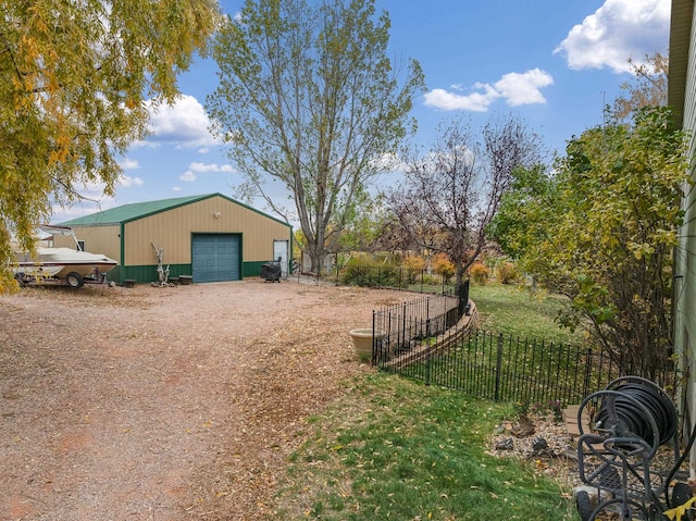 view of yard featuring a garage and an outbuilding