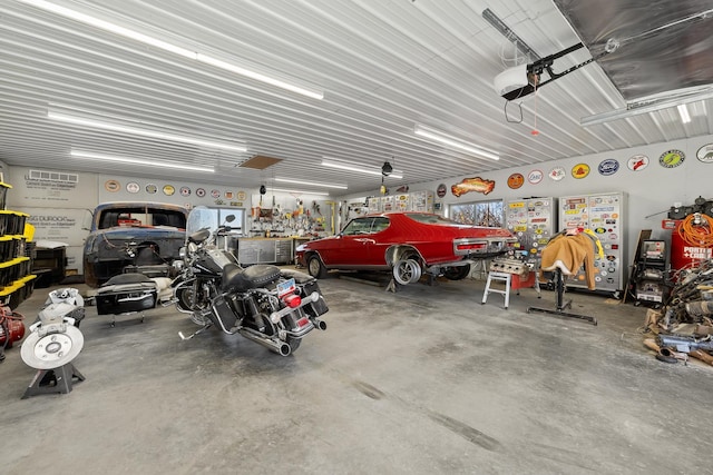 garage with a workshop area and a garage door opener