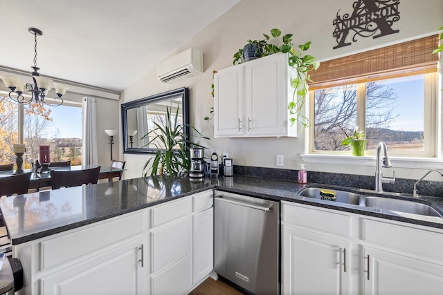 kitchen with stainless steel dishwasher, an AC wall unit, a wealth of natural light, and vaulted ceiling