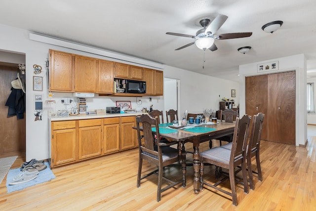 dining area featuring ceiling fan and light wood-type flooring