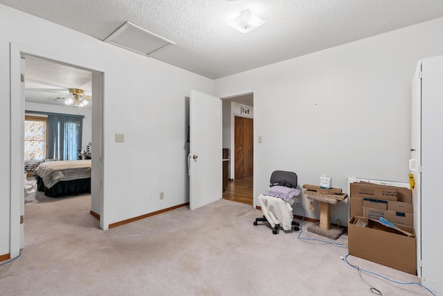 interior space featuring ceiling fan and a textured ceiling